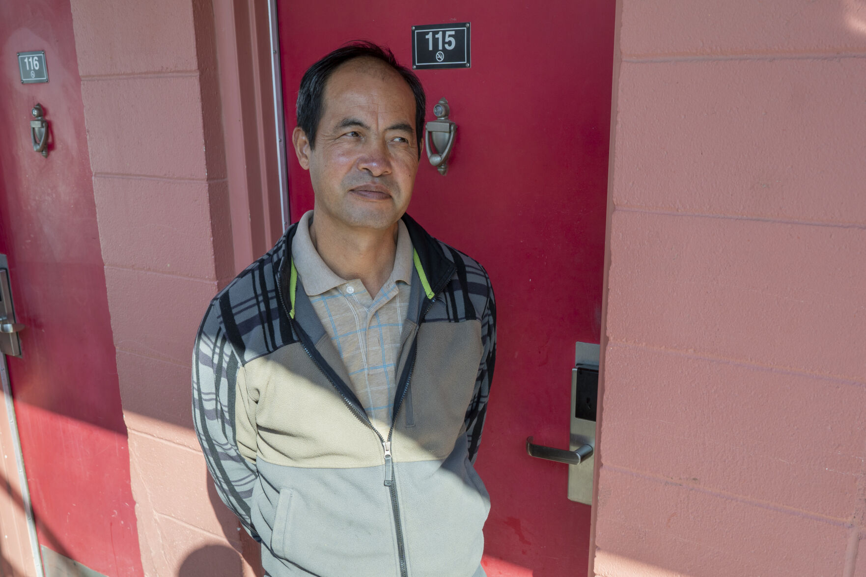 Qinliang Wang in front of his room at a motel in Farmington, where he came to do what he thought was legal “flower trimming” after being out of the workforce since March. Two days later, he was arrested in the room while pruning marijuana.
